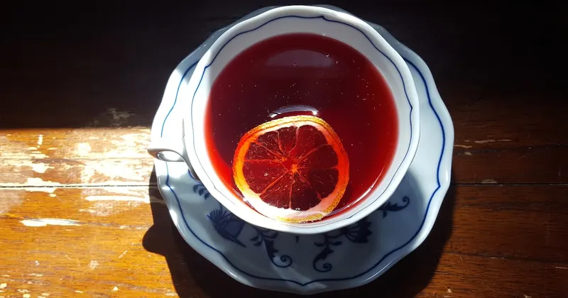 red liquid in clear drinking glass