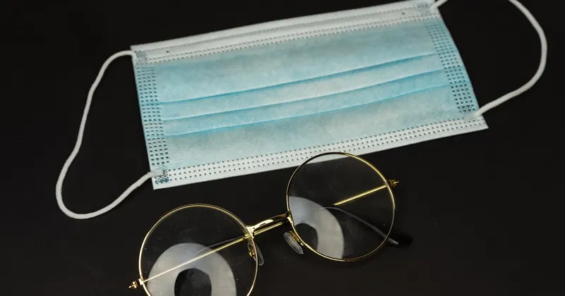 silver framed eyeglasses on black table